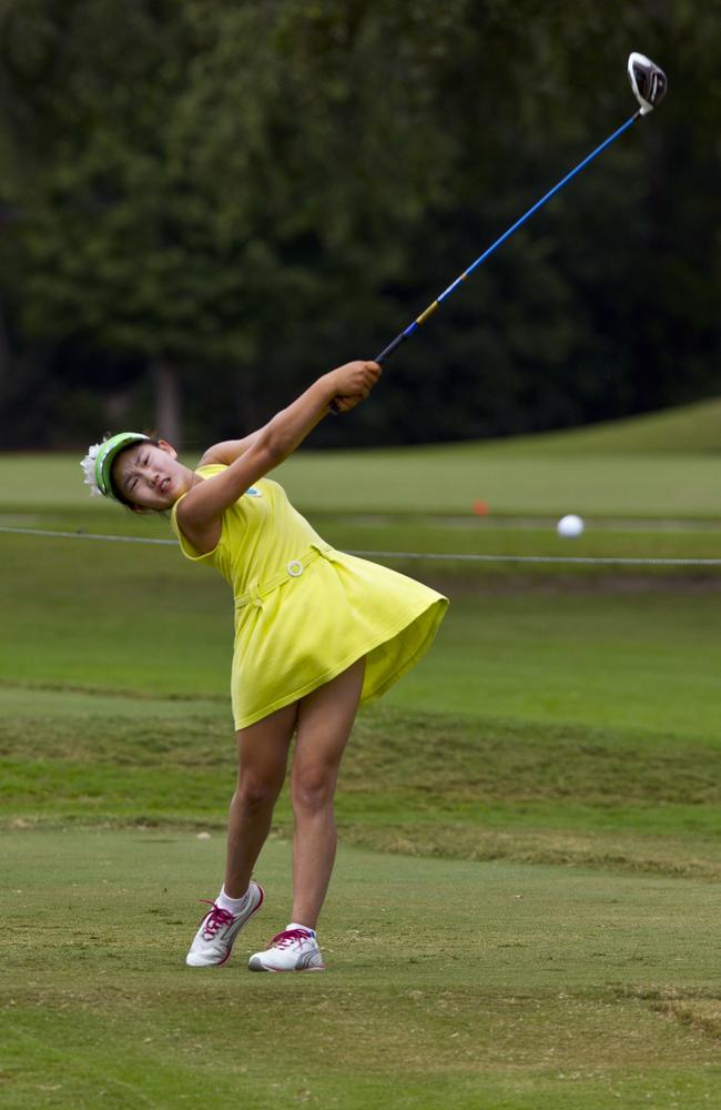 Lucy Li’s club is as tall as she is.