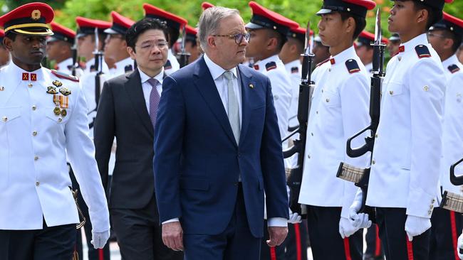 Mr Albanese and Mr Wong walk past a guard of honour. Picture: AFP