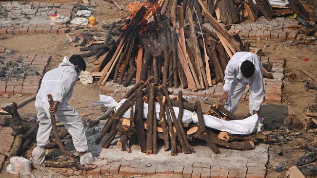 Relatives prepare the funeral pyre for their loved one in New Delhi. Picture: AFP