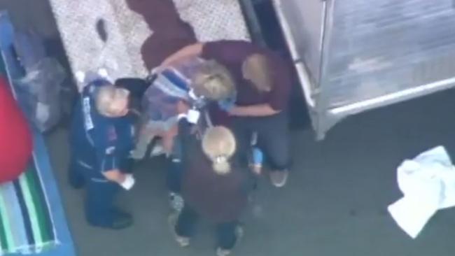 Ambulance officers treat a monkey bite victim at Village Roadshow <br/>Studios on the Gold Coast. Picture: Seven News