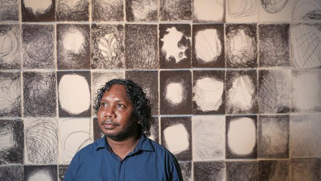 Ishmael Marika in front of his grandmothers award-winning artwork, Ms M Wirrpanda an award winner at the Telstra Aboriginal and Torres Strait Islander Art Awards Picture: Glenn Campbell