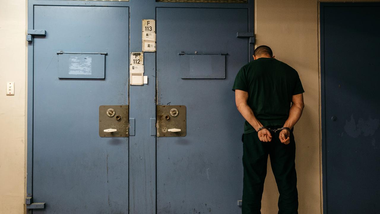 Inmate outside a cell during a search by prison officers at Silverwater Correctional Complex. Picture: Jonathan Ng.