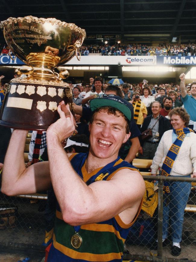 Eagles captain Peter Schwarz holds the Thomas Seymour Hill trophy aloft in 1993.