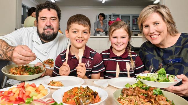 March 5, 2025: Africola head chef Duncan Welgemoed and Annesley Junior School principal Jo Rossiter serve up lunch for Year 3 students Mico and Charlotte, both 8 years old as part of the Budding Lunch program.  Picture: Brenton Edwards