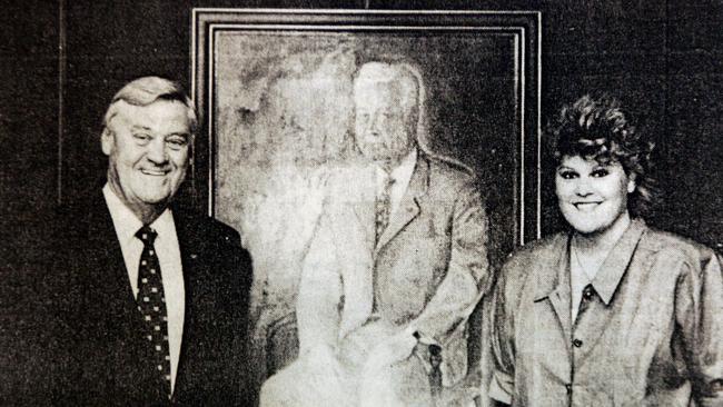 A 1991 picture of business coach Tracey Mathers and her father Sir Robert, standing by a painting of grandfather William. Picture: David/Clark