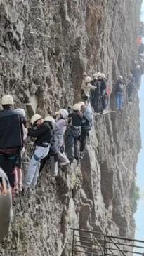 Tourists stranded on terrifying cliff face climb