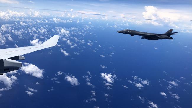 A US Air Force B-1 Lancer aircraft alongside a Royal Australian Air Force KC-30A Multi-Role Tanker Transport aircraft above Guam