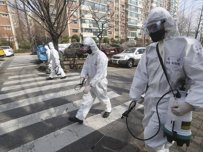 South Korean army soldiers spray disinfectant as a precaution against a new coronavirus on a street in Seoul, South Korea. Picture: Ahn Young-Joon