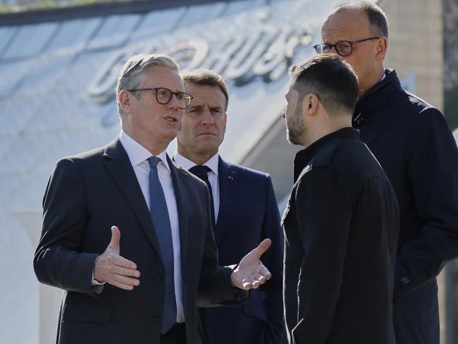 Britain's Prime Minister Keir Starmer, left, talks to Ukraine's President Volodymyr Zelensky, 2nd right, as France's President Emmanuel Macron, 2nd left, and Germany's Chancellor Friedrich Merz stand behind after a group photo at the Independence Square in Kyiv. Picture: AP