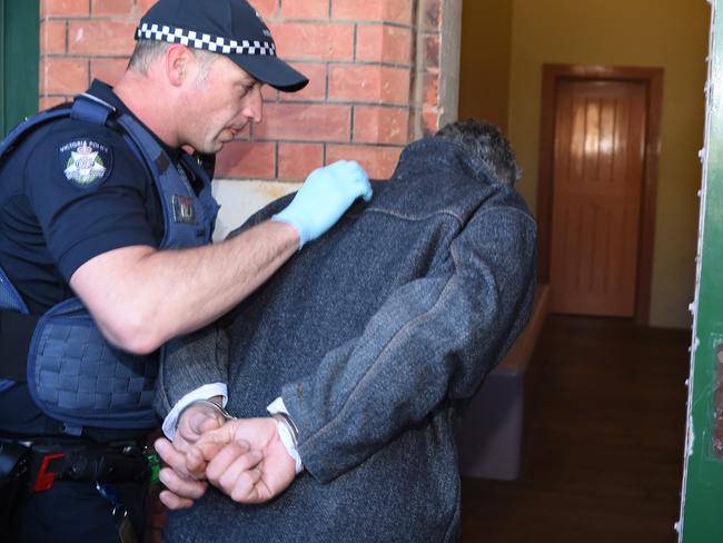 Adrian Basham is taken into Bairnsdale Magistrate’s Court on Thursday. Picture: Lawrence Pinder