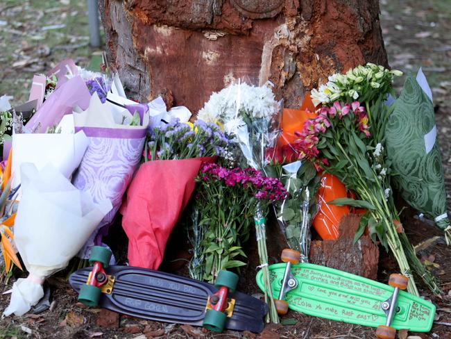 Flowers and tributes at a crash scene on Cabbage Tree Rd crash. Picture: Damian Shaw