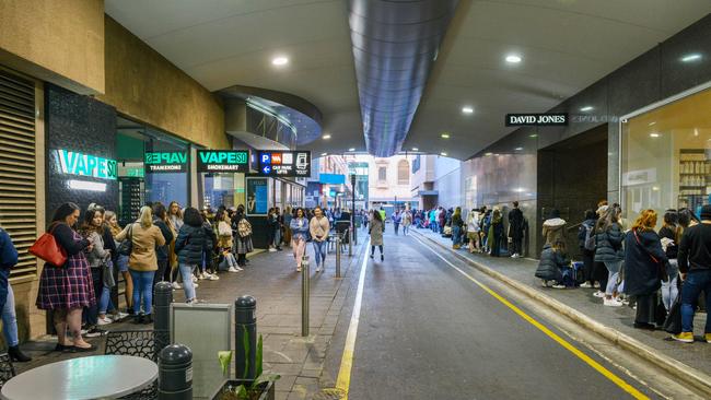 A line of people stretching to North Terrace waiting for the opening of Sephora in Rundle Mall. Picture: AAP/Brenton Edwards