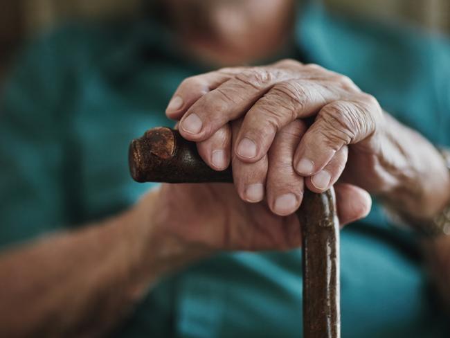 BAD AGED CARE:   Cropped shot of an unrecognizable man leaning on his walking stick