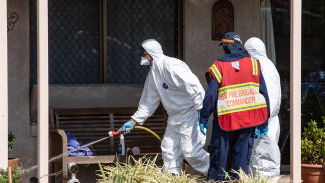 Emergency services workers at the house on Sunday where Eric Newman shot police officers from his balcony. Picture: Julian Andrews.