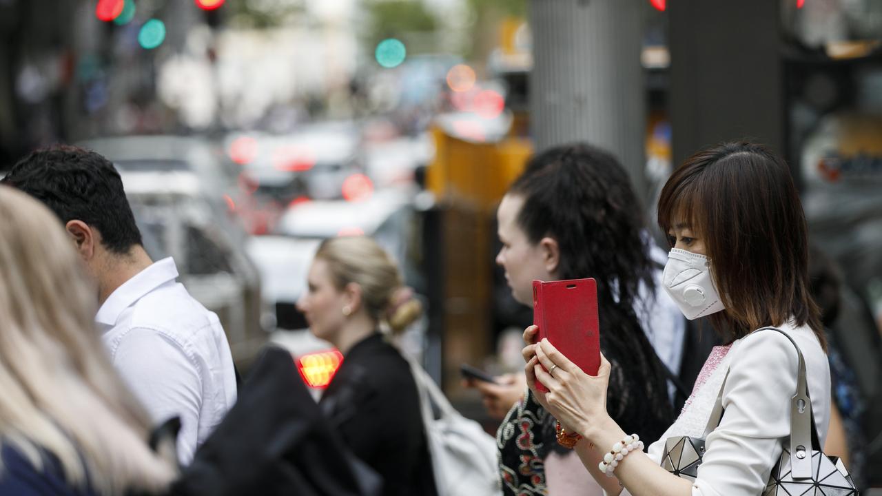 Mask are commonly now being worn around the Sydneys CBD due to the fear of the Coronavirus. Photo: Tim Pascoe