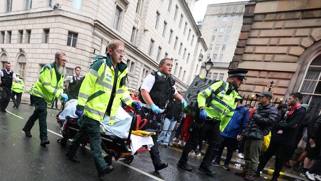 Emergency services assist the injured after a man drove a car through a group of pedestrians on hand to watch Liverpool football club’s title celebrations Picture: Getty Images