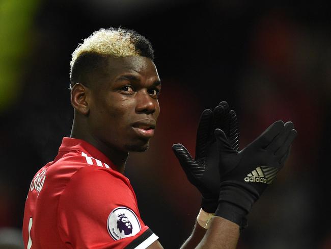 Manchester United's French midfielder Paul Pogba applauds the fans at the end of the English Premier League football match between Manchester United and Stoke City at Old Trafford in Manchester, north west England, on January 15, 2018. / AFP PHOTO / Oli SCARFF / RESTRICTED TO EDITORIAL USE. No use with unauthorized audio, video, data, fixture lists, club/league logos or 'live' services. Online in-match use limited to 75 images, no video emulation. No use in betting, games or single club/league/player publications.  /