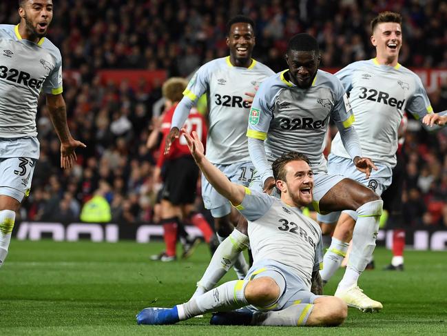 Derby's English striker Jack Marriott (C) celebrates scoring his team's second goal during the English League Cup third round football match between Manchester United and Derby County at Old Trafford in Manchester, north west England, on September 25, 2018. (Photo by Paul ELLIS / AFP) / RESTRICTED TO EDITORIAL USE. No use with unauthorized audio, video, data, fixture lists, club/league logos or 'live' services. Online in-match use limited to 120 images. An additional 40 images may be used in extra time. No video emulation. Social media in-match use limited to 120 images. An additional 40 images may be used in extra time. No use in betting publications, games or single club/league/player publications. /