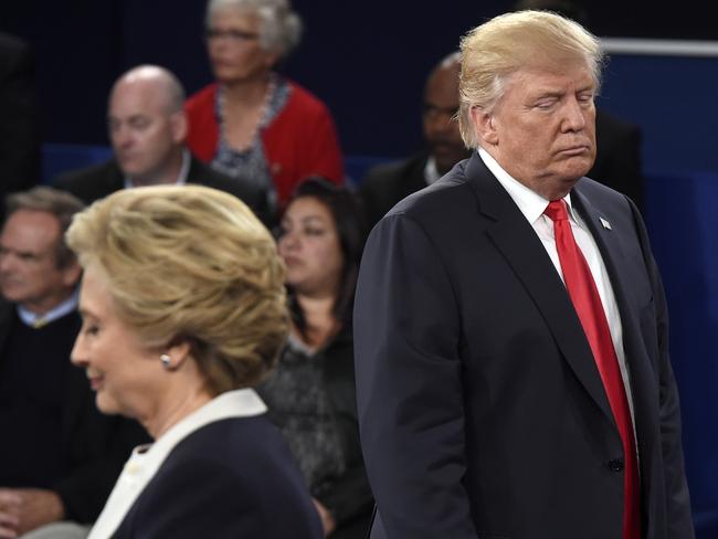 Republican presidential nominee Donald Trump, right, and Democratic presidential nominee Hillary Clinton listen to a question during the second presidential debate. Picture: Saul Loeb/Pool via AP