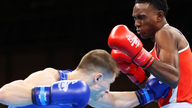 Billy Polkinghorn of Team Australia (Blue) punches Fabio Taryll Liam Roselie of Team Seychelles