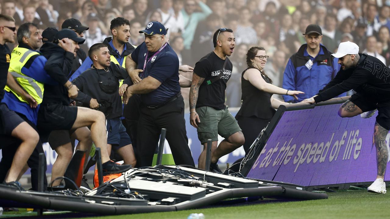 Fans storm the pitch during the round eight A-League Men's match between Melbourne City and Melbourne Victory at AAMI Park, on December 17, 2022, in Melbourne, Australia. (Photo by Darrian Traynor/Getty Images)