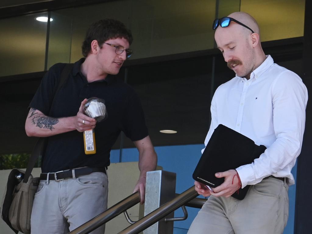 Two wind farm contractors Liam Parnell (white shirt) and Matthew Garbutt (black shirt) leaving Mackay courthouse after giving evidence in the committal hearing of triple murder accused Darryl Valroy Young.