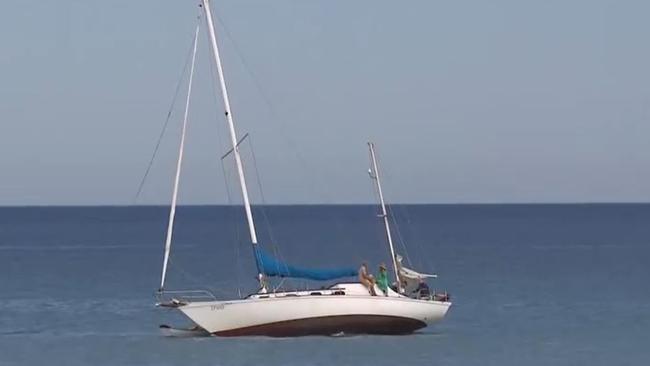 Police rescue some boaties after their yacht becomes stuck on a sandbar off of Semaphore . Picture: 7NEWS