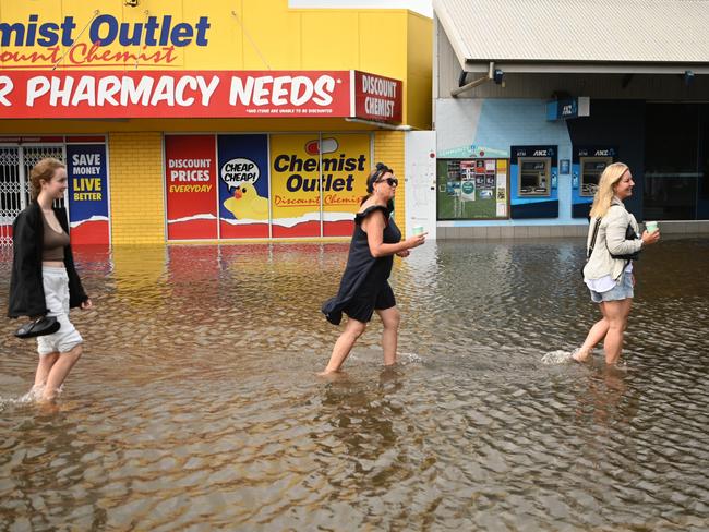 People walk through floodwater in Byron Bay on Wednesday. Picture: Getty