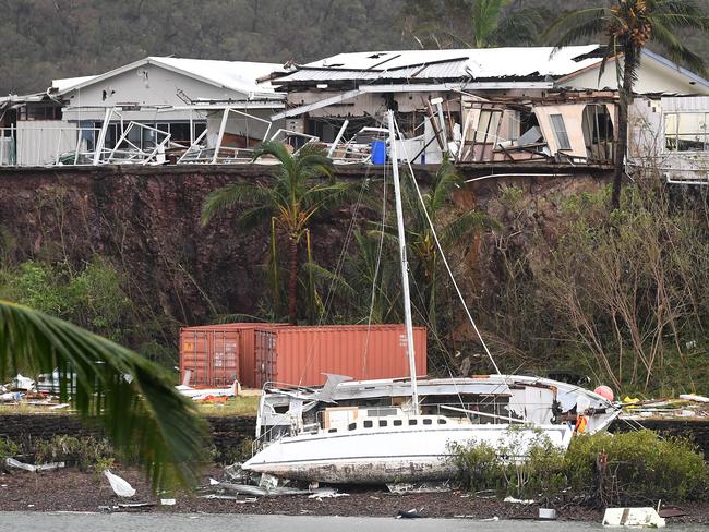 A boat is seen smashed against the bank at Shute Harbour, Airlie Beach, Wednesday, March 29, 2017. Picture: AAP Image/Dan Peled