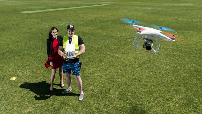 Drone pilot Chris Garnaut, shows Vetti Kakulas the ropes to flying a drone. Picture: News Corp Australia