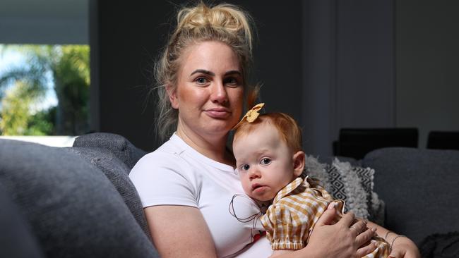 Meagan Hammond at home with daughter Lukah, 1. Miss Hammond is battling the National Disability Insurance Scheme who have cut funding to her only treatment. Picture Lachie Millard