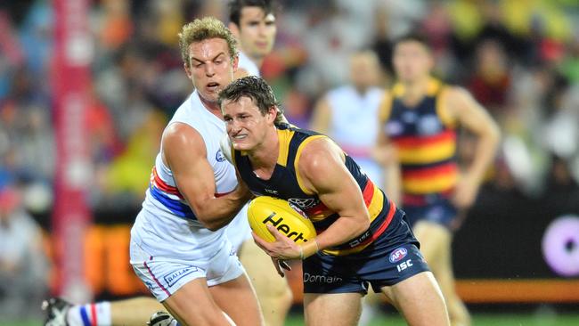 Adelaide’s Matt Crouch of the Crows (right) and Western Bulldogs Mitch Wallis clash during the Round 16 AFL match at Adelaide Oval. Picture AAP /David Mariuz.