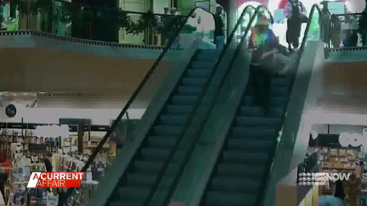 The man in the rainbow hoodie walked down the escalator after allegedly pushing the Dymocks worker. Picture: 9 News/ A Current Affair.