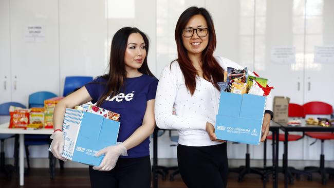 Priscilla Liem (right) from Our Lady of the Rosary Parish in Fairfield has helped support nearly 50 families in the area during the pandemic by packing food hampers. Pictured with volunteer Julie Nguyen (left). Picture: Sam Ruttyn