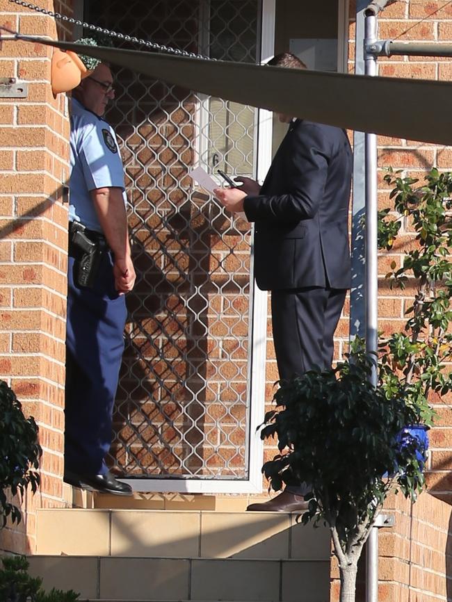 Police at the Yagoona home. Picture John Grainger