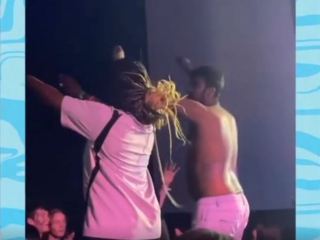 A shirtless reveller dances next to a young woman at the Hillsong youth ‘Summercamp’ event in Newcastle on Wednesday.