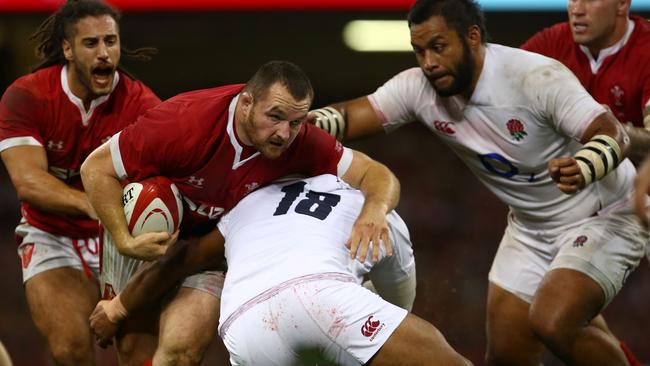 TOPSHOT - Wales' hooker Ken Owens (2L) is tackled by England's prop Kyle Sinckler (C) during the international Test rugby union match between Wales and England at Principality Stadium in Cardiff, south Wales on August 17, 2019. (Photo by GEOFF CADDICK / AFP) / RESTRICTED TO EDITORIAL USE. Use in books subject to Welsh Rugby Union (WRU) approval.