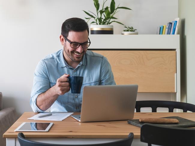 CAREERS: Happy young businessman using laptop and work from home