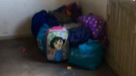 A Dora the Explorer bag among piles of junk in a Southport squat house where thousands of needles were found.