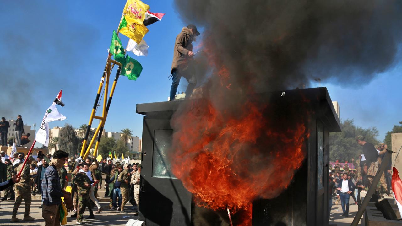 Protesters burn property in front of the U.S. embassy compound, in Baghdad, Iraq. Picture: AP Photo/Khalid Mohammed