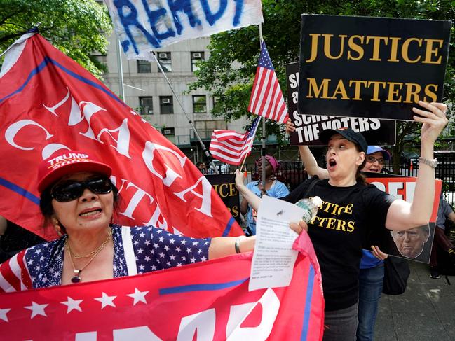 Supporters and opponents of Mr Trump outside the Manhattan Criminal Court. Picture: AFP