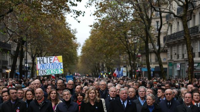 French senate president Gerard Larcher, president of the French National Assembly Yael Braun-Pivet, French Prime Minister Elisabeth Borne, France's former president Nicolas Sarkozy and France's former president Francois Hollande among the crowd singing the French national anthem as they stand behind a banner which reads as For The Republic, Against anti-Semitism during a march in Paris on November 12. Picture: AFP