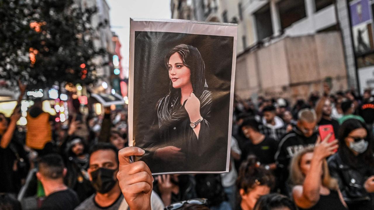 A protester holds a portrait of Mahsa Amini during a demonstration in support of Amini. Picture: Ozan KOSE / AFP