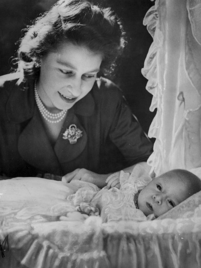 Princess Elizabeth with her month old baby son Prince Charles in his cradle in 1948.