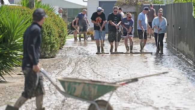 Residents in Taradale clean up silt following flood waters. Picture: Getty Images