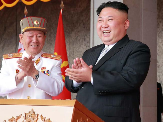 A smirking Kim Jong-un watched a fervent military parade just hours after telling America: “We’re ready for war.” Picture: AFP