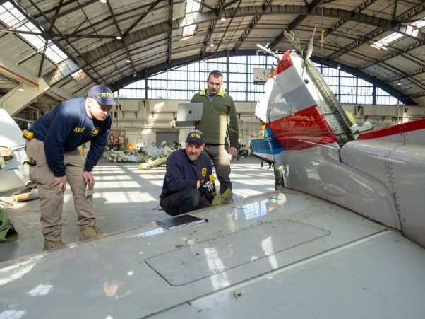 Investigators inspect the wing of the doomed American Airlines flight. Picture: NTSB