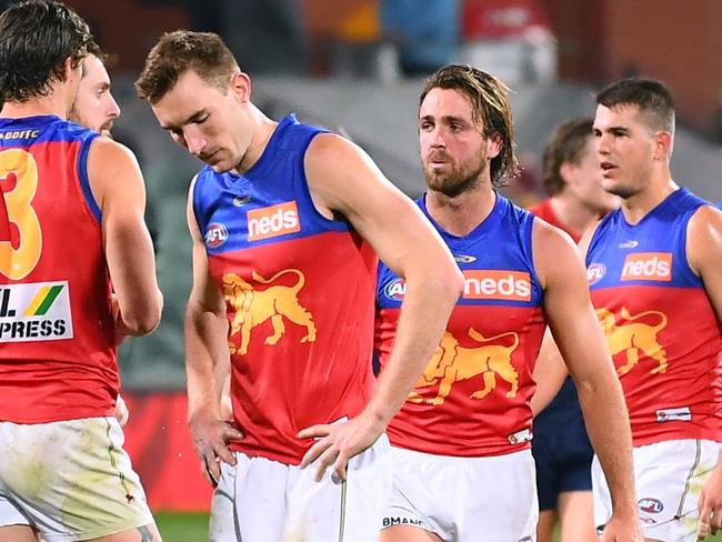 ADELAIDE, AUSTRALIA - AUGUST 28: Dejected Brisbane players after losing  the AFL First Qualifying Final match between Melbourne Demons and Brisbane Lions at Adelaide Oval on August 28, 2021 in Adelaide, Australia. (Photo by Mark Brake/Getty Images)