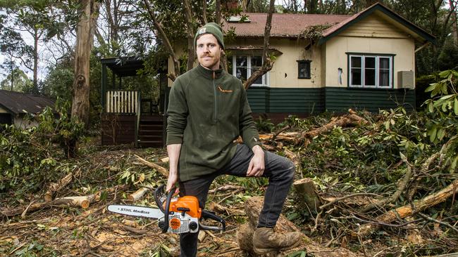 Olinda resident Aaron Brown out the front of his home that saw significant damage during recent storms. Picture: Aaron Francis