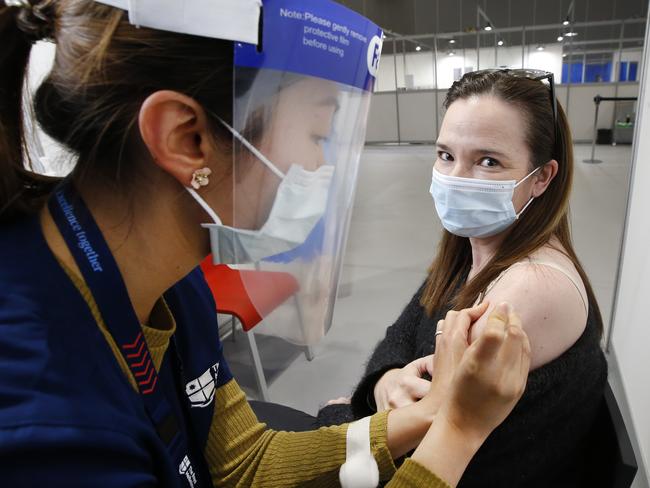 Crowds flock to vaccine hubs to get the jab after the COVID lockdown was announced at the Melbourne Exhibition Centre. Samantha Douglas 49, of Kew East prepares to get her vaccine.                        Picture: David Caird